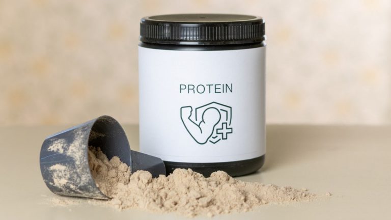 Chocolate protein supplement jar and scoop, muscle recovery and fitness. Protein is part of my daily training routine → linktr.ee/alexsaks.inspiration