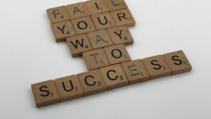 scrabble, scrabble pieces, lettering, letters, wood, scrabble tiles, white background, words, quote, fail your way to success, persevere, don't give up, try again, get up, move on, keep innovating,